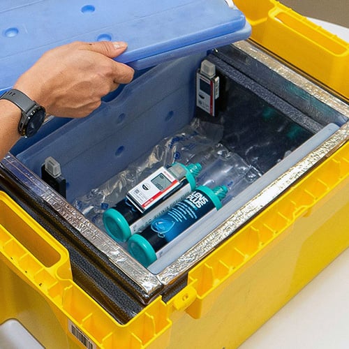 Employee places a cold pack in the delivery box.