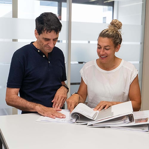 Project team members look at documents in the folder.